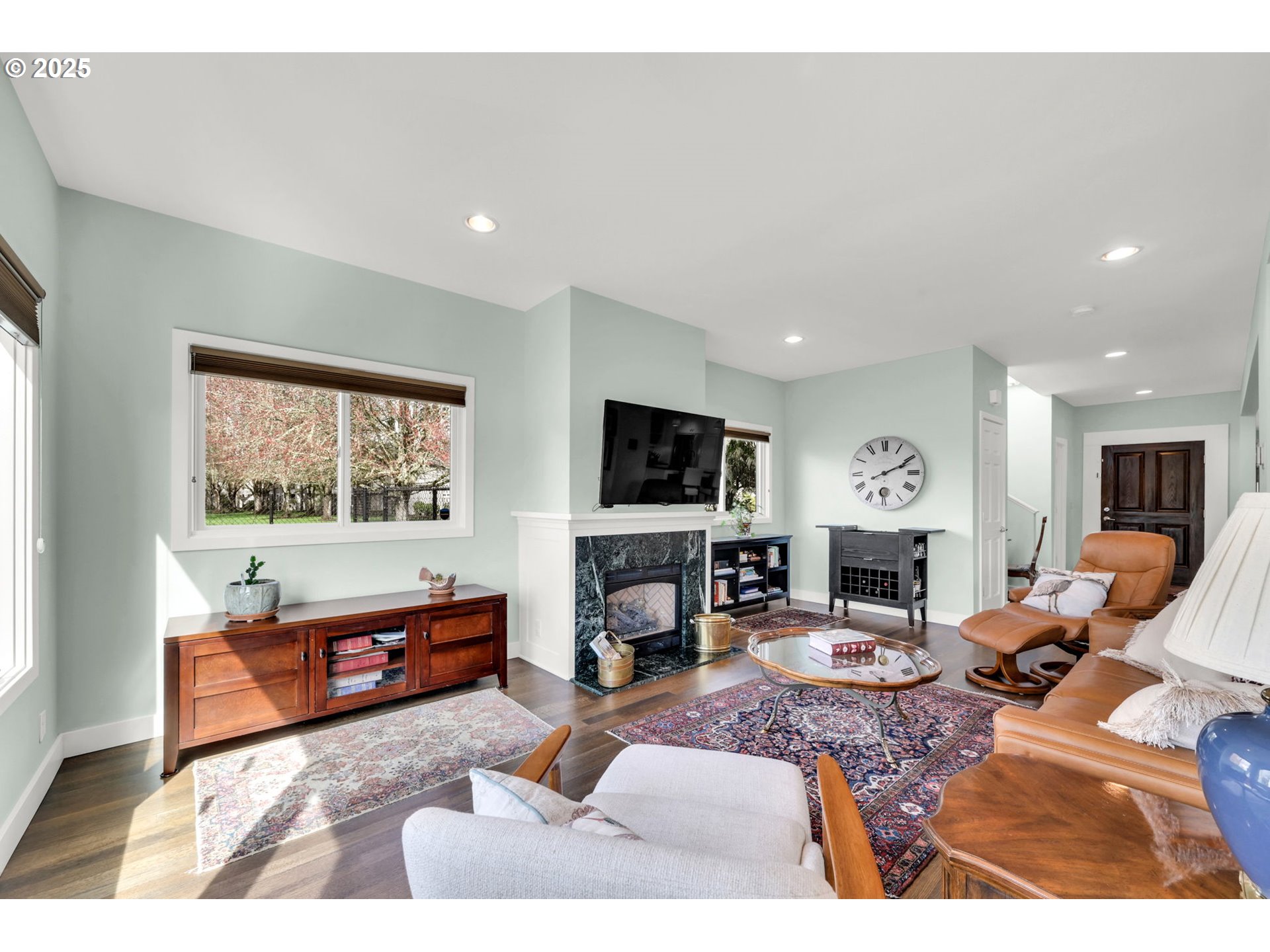 579 Wimbledon Court Eugene, OR 97401 - Photo 13 of 46 a living room with furniture a flat screen tv and a fireplace