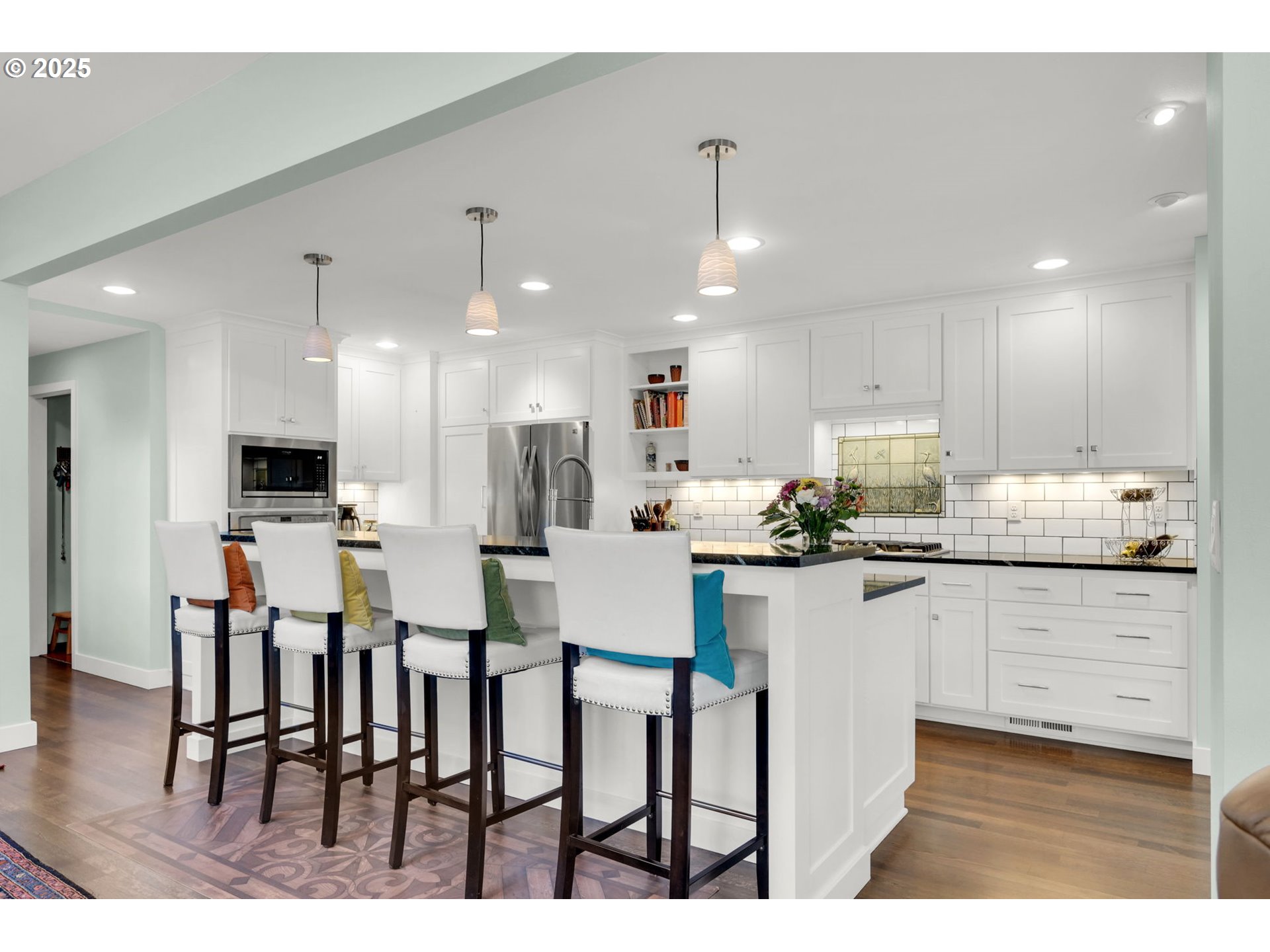 579 Wimbledon Court Eugene, OR 97401 - Photo 17 of 46 a kitchen with stainless steel appliances kitchen island granite countertop a dining table chairs and sink