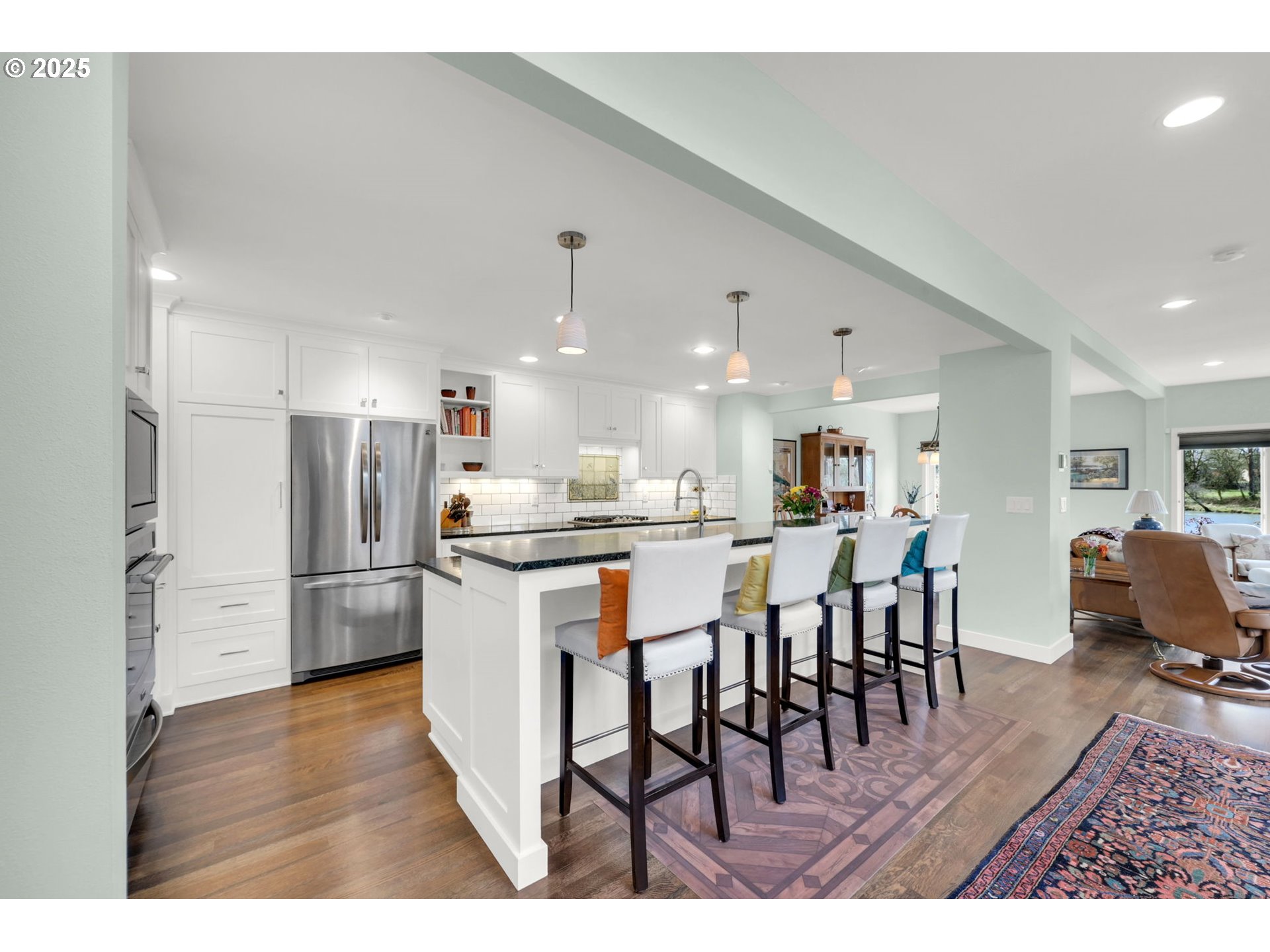 579 Wimbledon Court Eugene, OR 97401 - Photo 19 of 46 a kitchen with stainless steel appliances kitchen island granite countertop a table chairs and a refrigerator