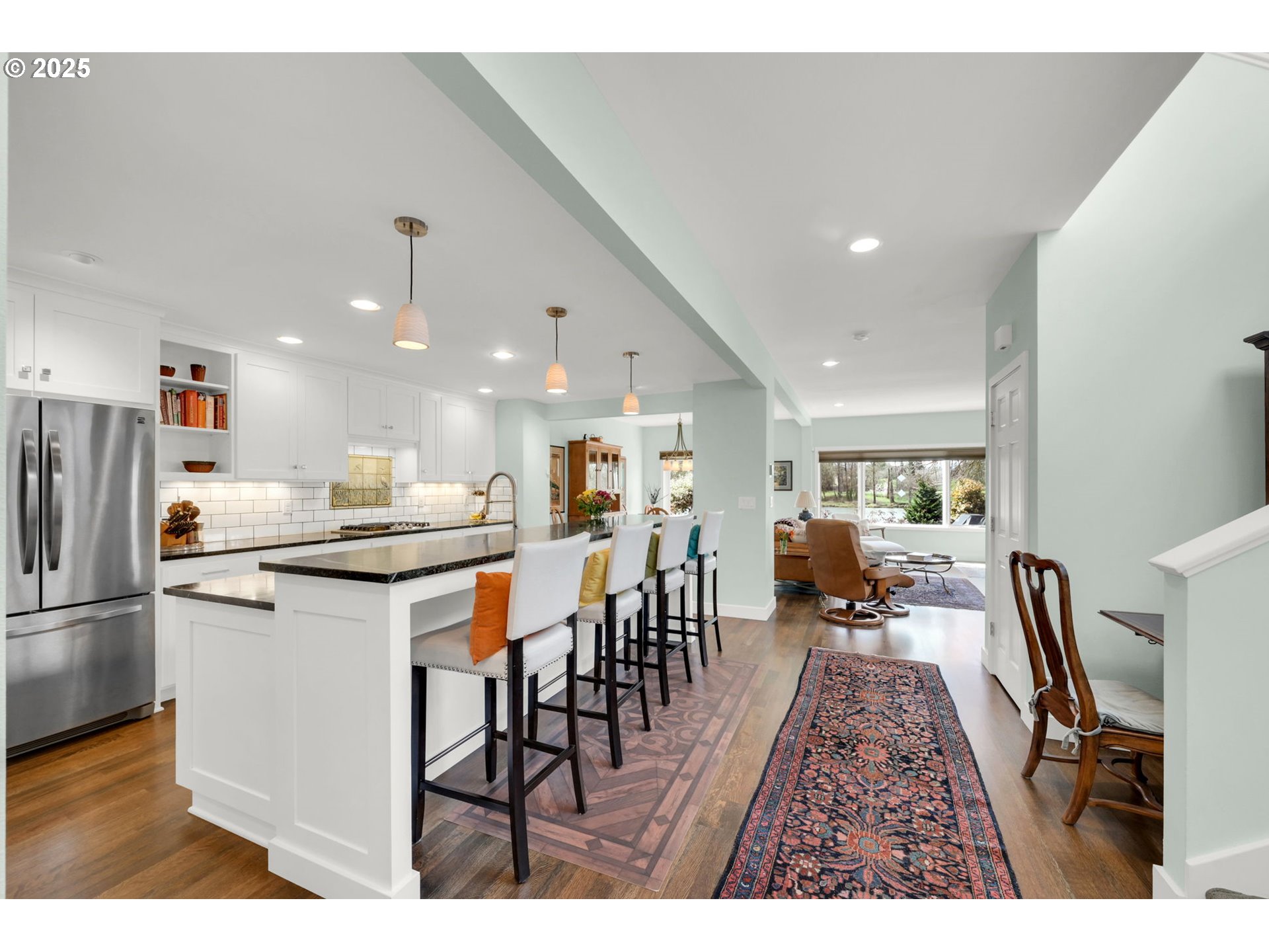 579 Wimbledon Court Eugene, OR 97401 - Photo 20 of 46 a open kitchen with stainless steel appliances kitchen island granite countertop a refrigerator a stove a sink a dining table and chairs with wooden floor