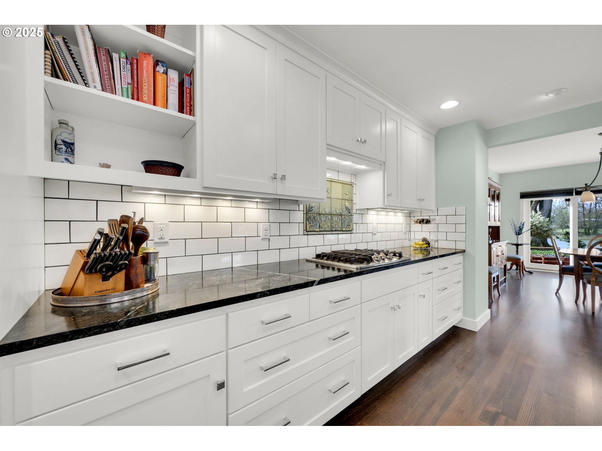 579 Wimbledon Court Eugene, OR 97401 - Photo 21 of 46 a kitchen with granite countertop white cabinets and wooden floor