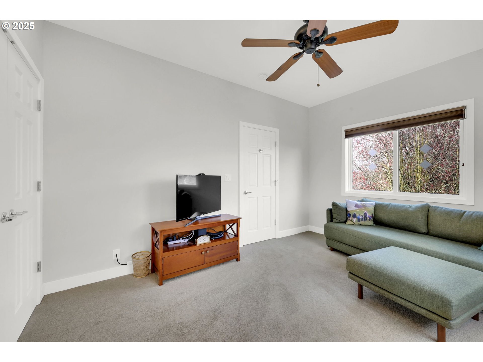 579 Wimbledon Court Eugene, OR 97401 - Photo 31 of 46 a living room with furniture and a flat screen tv