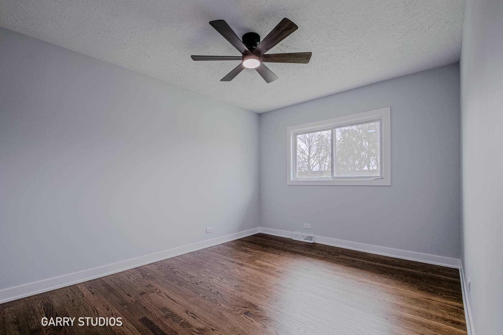 1212 North Wheeling Road Mount Prospect, IL 60056 - Photo 11 of 19 an empty room with wooden floor and ceiling fan