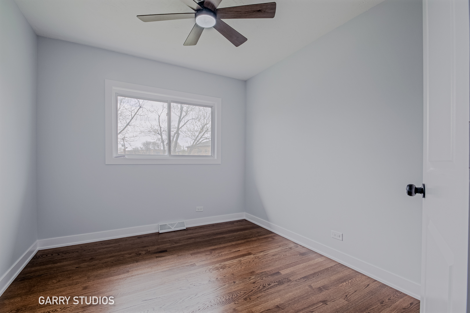 1212 North Wheeling Road Mount Prospect, IL 60056 - Photo 12 of 19 an empty room with wooden floor fan and windows