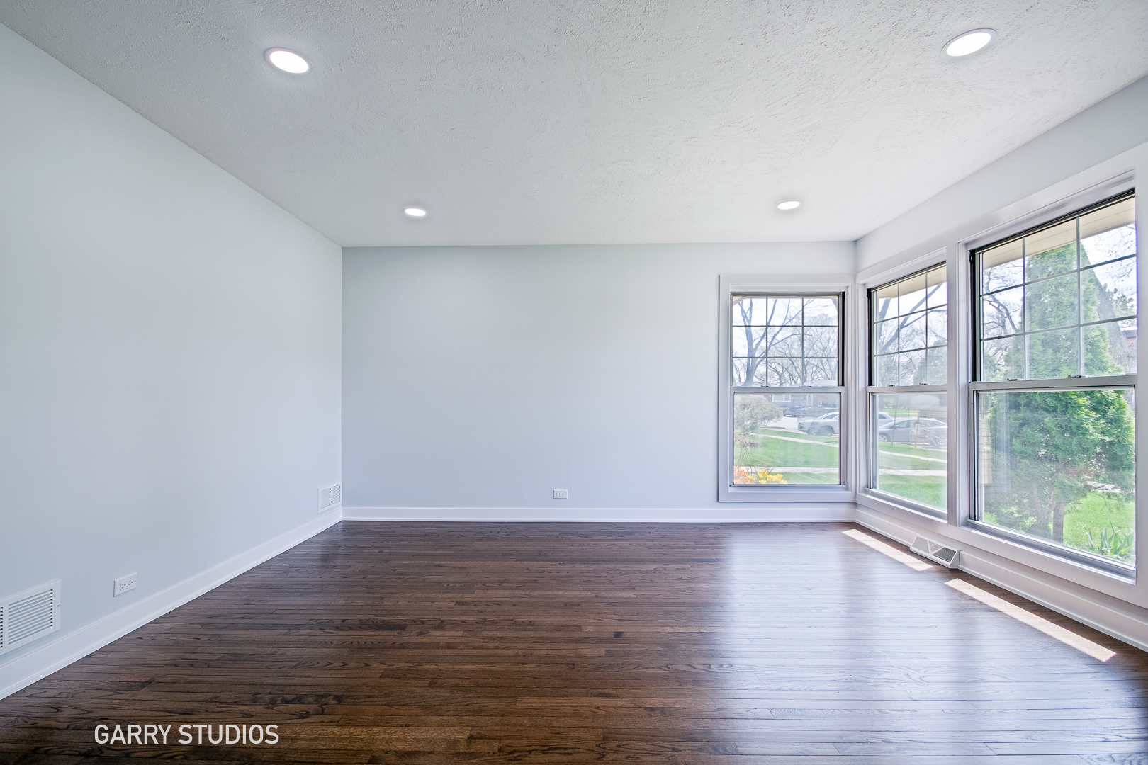1212 North Wheeling Road Mount Prospect, IL 60056 - Photo 2 of 19 a view of an empty room with wooden floor and a window