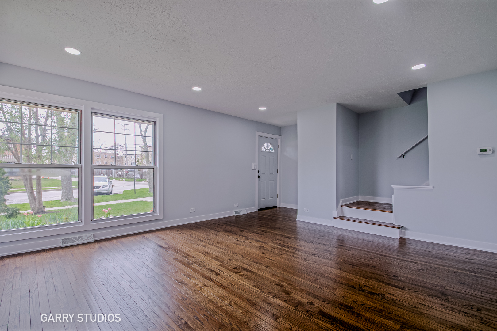 1212 North Wheeling Road Mount Prospect, IL 60056 - Photo 3 of 19 an empty room with wooden floor and windows