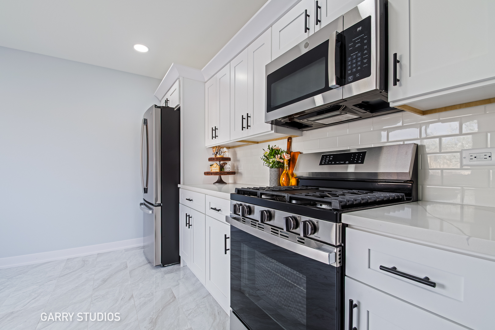1212 North Wheeling Road Mount Prospect, IL 60056 - Photo 4 of 19 a kitchen with stainless steel appliances a stove a microwave and cabinets