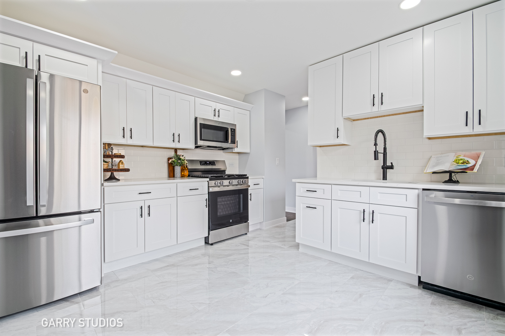 1212 North Wheeling Road Mount Prospect, IL 60056 - Photo 5 of 19 a kitchen with white cabinets and white appliances