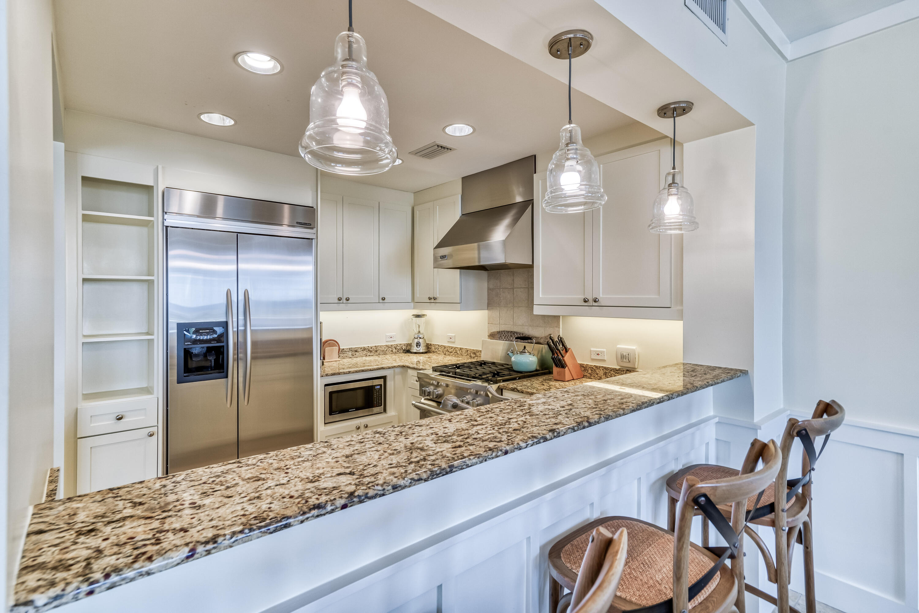 100 Bridge Lane, Unit C112 Watersound, FL 32461 - Photo 11 of 43 a kitchen with a table chairs refrigerator and microwave