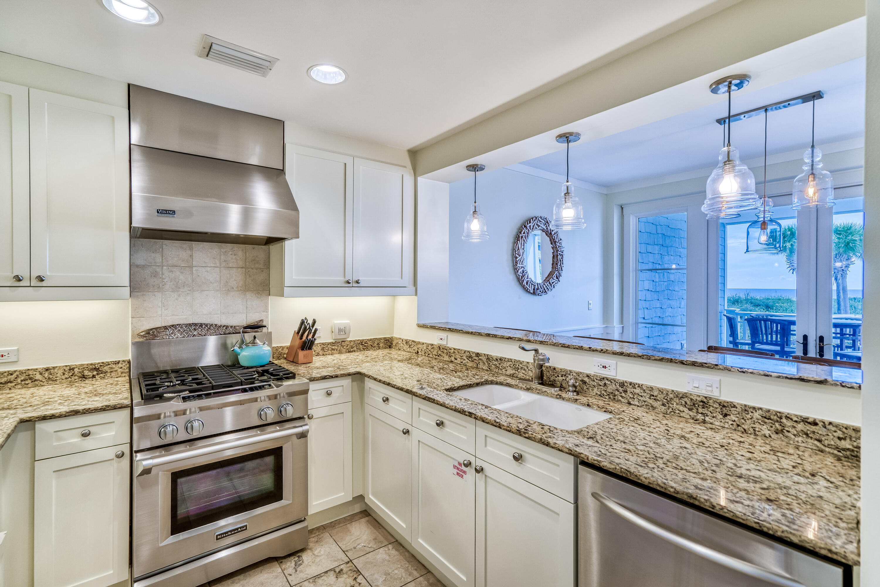 100 Bridge Lane, Unit C112 Watersound, FL 32461 - Photo 13 of 43 a kitchen with granite countertop a sink stainless steel appliances and cabinets