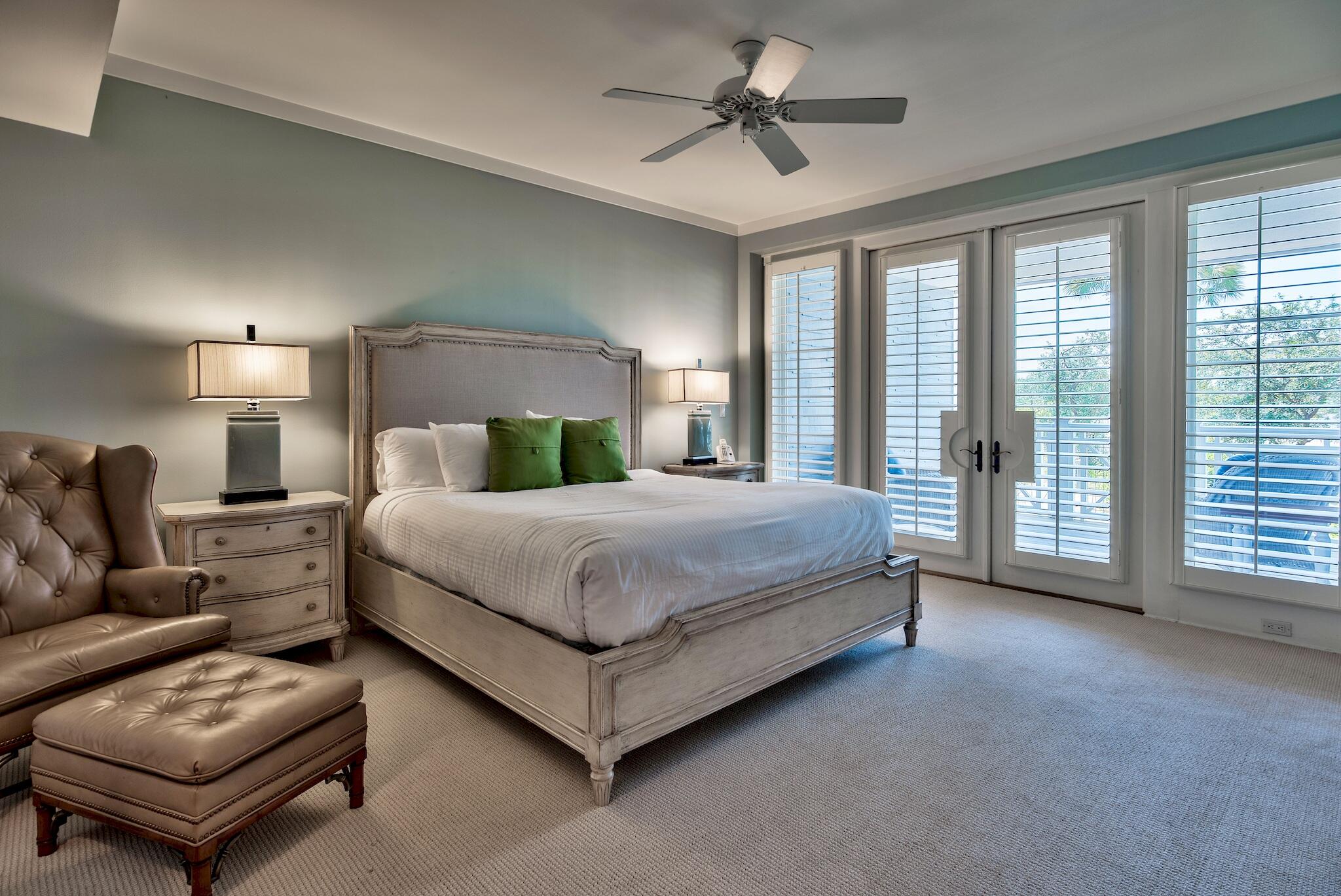 100 Bridge Lane, Unit C112 Watersound, FL 32461 - Photo 25 of 43 a spacious bedroom with a bed a couch and a ceiling fan