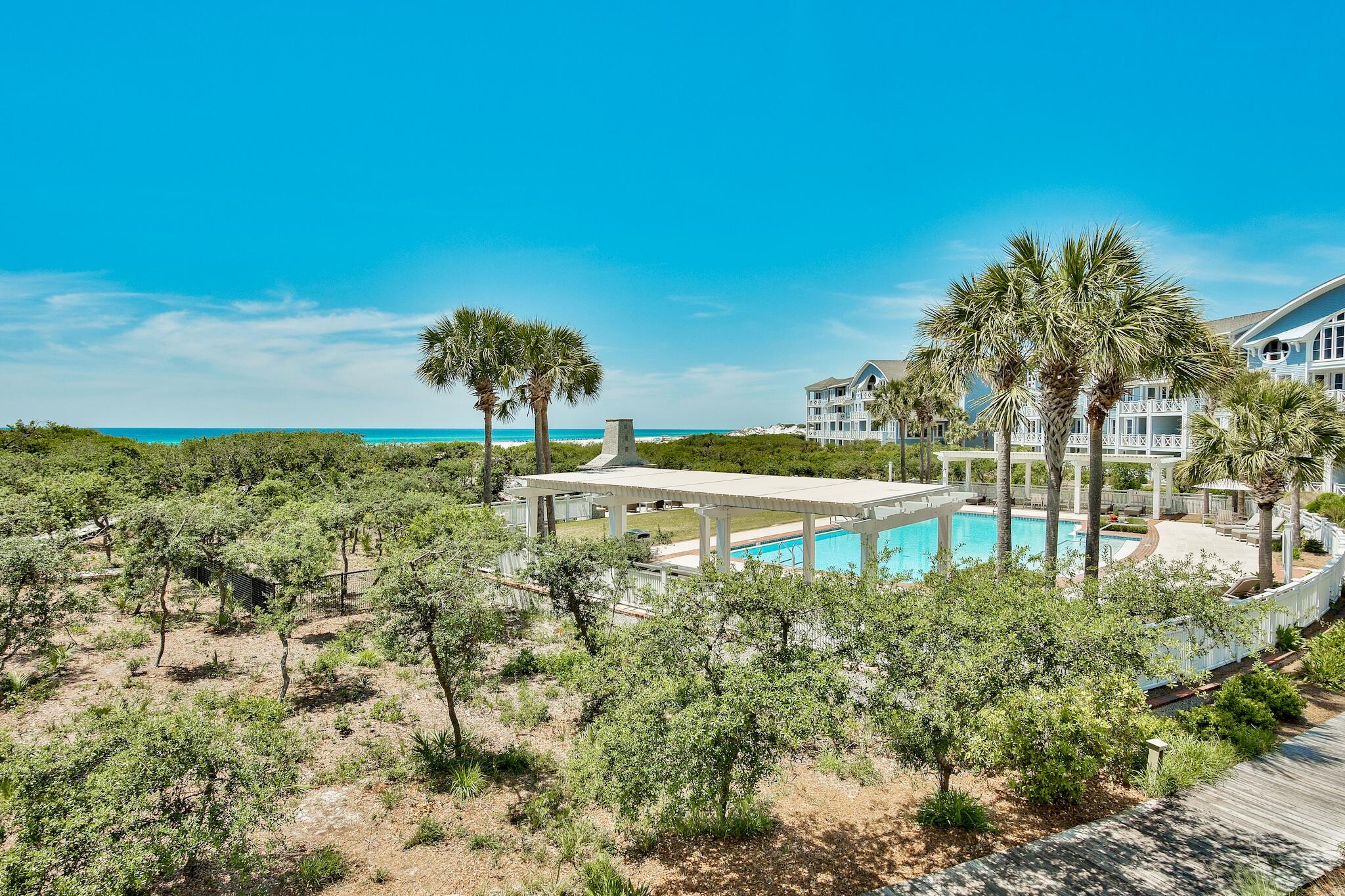100 Bridge Lane, Unit C112 Watersound, FL 32461 - Photo 35 of 43 a view of a lake with a building in the background
