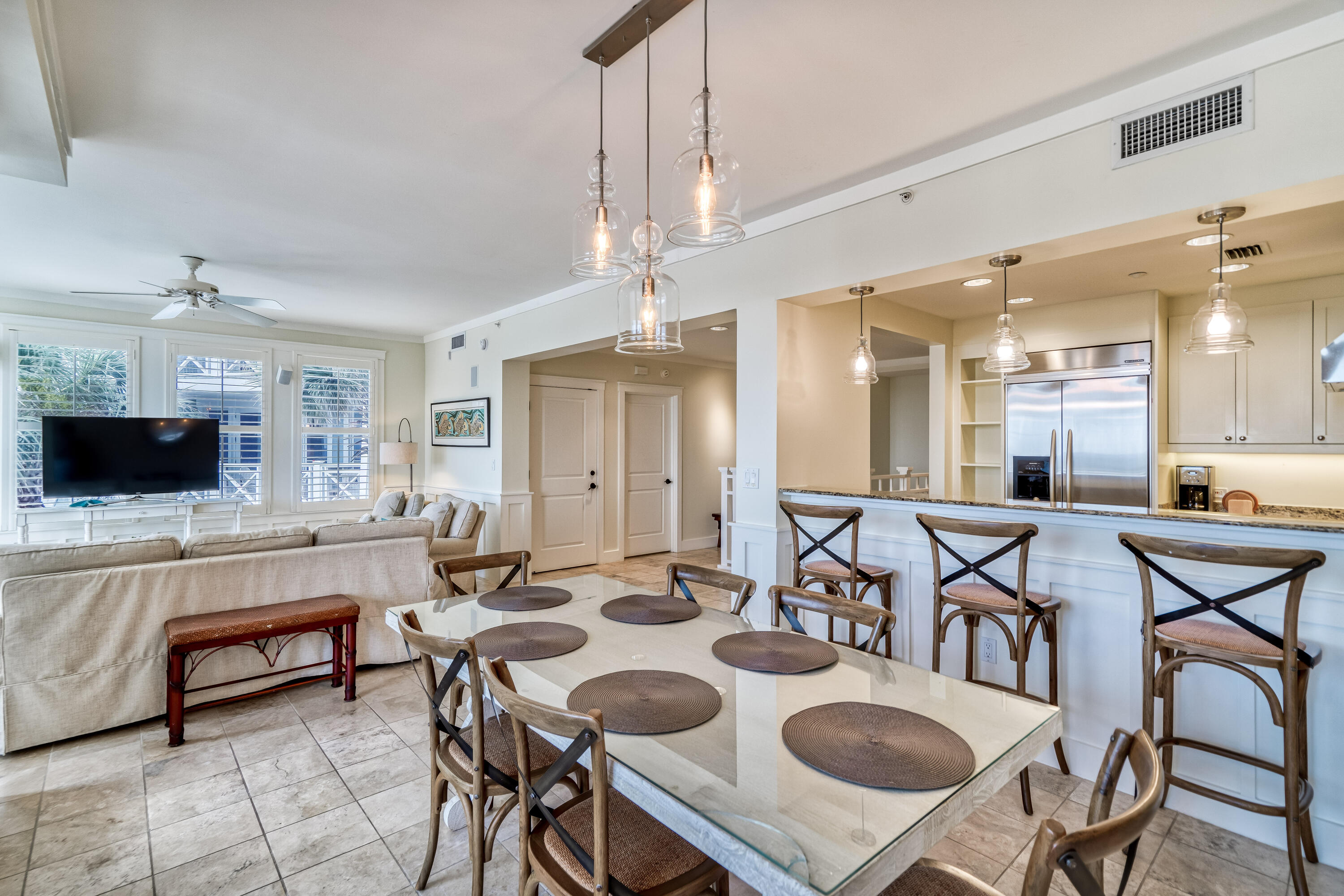 100 Bridge Lane, Unit C112 Watersound, FL 32461 - Photo 9 of 43 a view of a dining room with furniture and a flat screen tv
