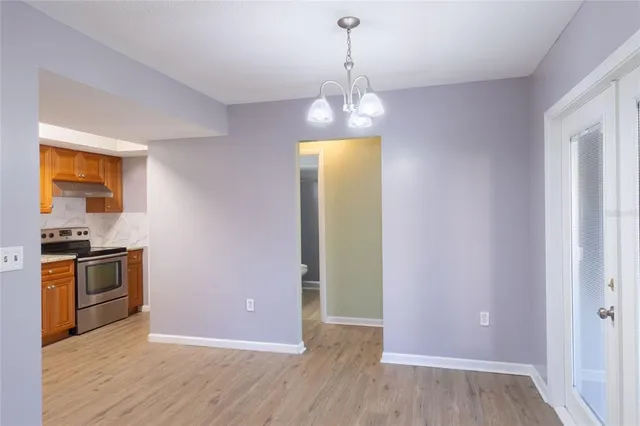 a view of a kitchen with a sink wooden floor and a window