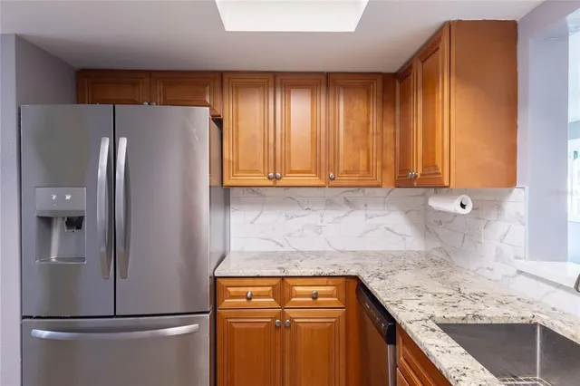 a kitchen with a refrigerator and a sink