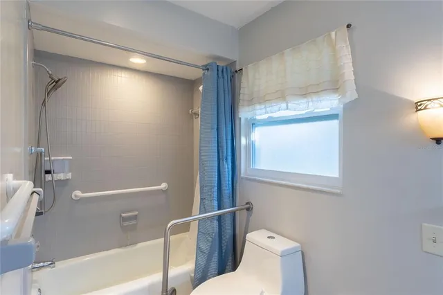 a bathroom with a toilet and a bathtub