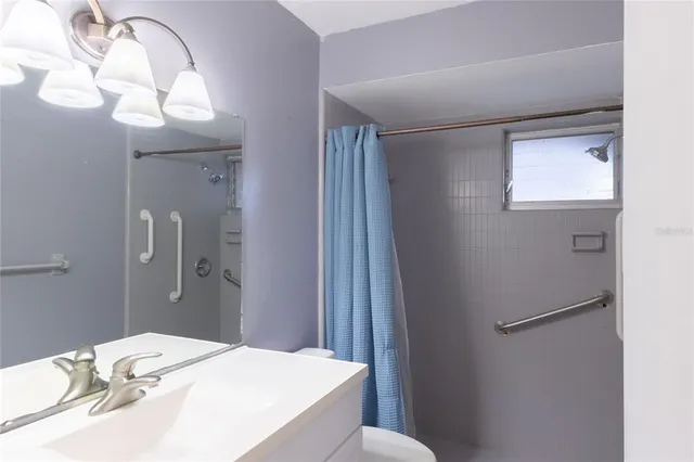 a bathroom with a sink mirror and vanity