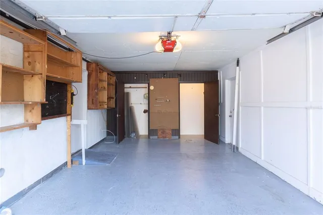 a view of a hallway with a dining table and chairs
