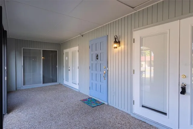 a view of a hallway with wooden shelves