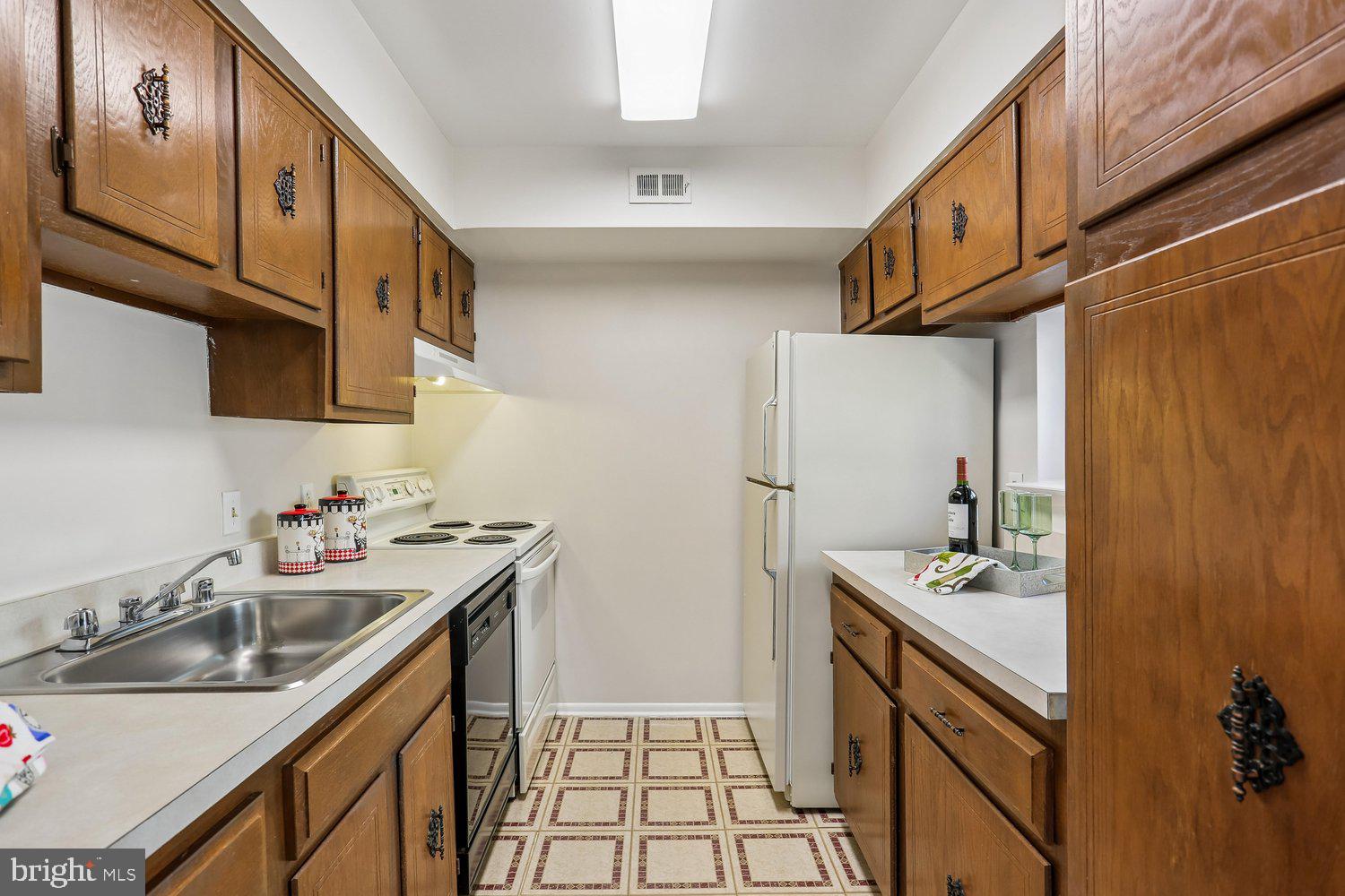 15020 Eardley Court, Unit 281G Silver Spring, MD 20906 - Photo 11 of 20 a kitchen with stainless steel appliances a sink stove and cabinets