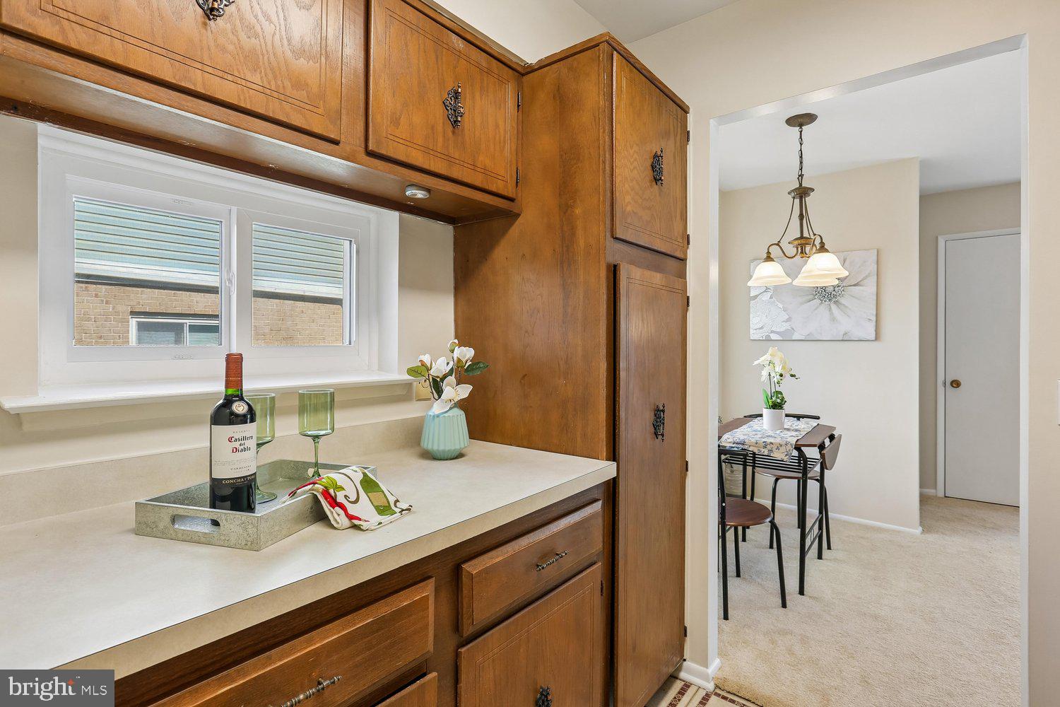 15020 Eardley Court, Unit 281G Silver Spring, MD 20906 - Photo 13 of 20 a kitchen with a refrigerator and table