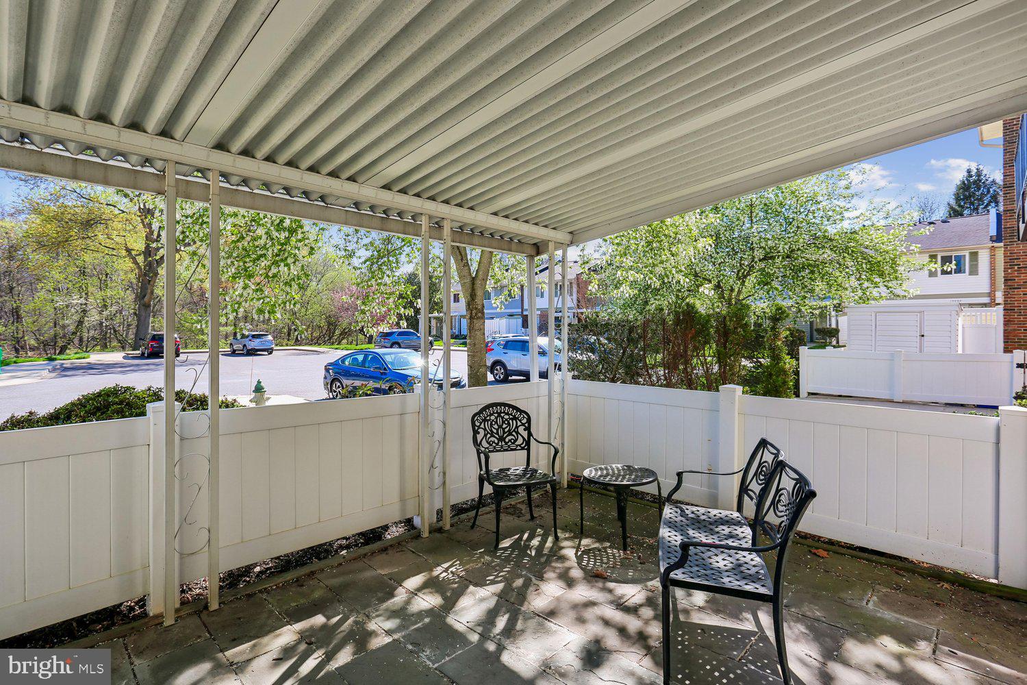 15020 Eardley Court, Unit 281G Silver Spring, MD 20906 - Photo 14 of 20 a view of a patio with table and chairs and couches with wooden floor and fence