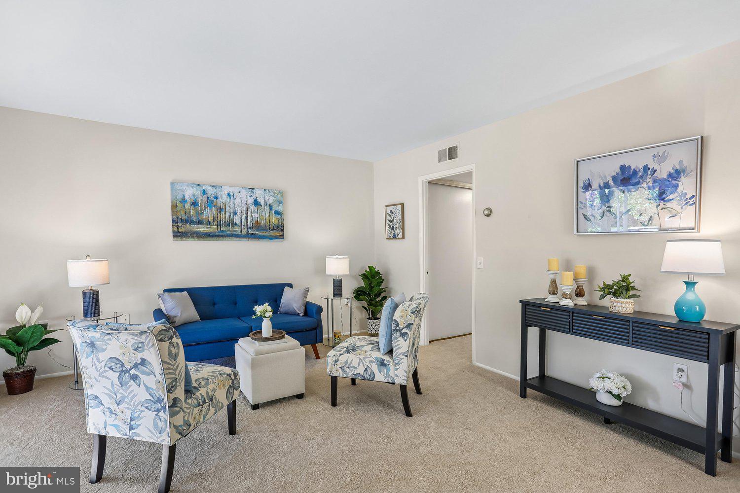 15020 Eardley Court, Unit 281G Silver Spring, MD 20906 - Photo 7 of 20 a living room with furniture and a painting on the wall