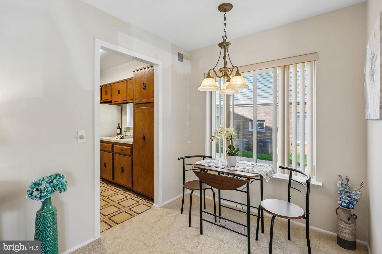 15020 Eardley Court, Unit 281G Silver Spring, MD 20906 - Photo 10 of 20 a dining room with furniture a chandelier and window