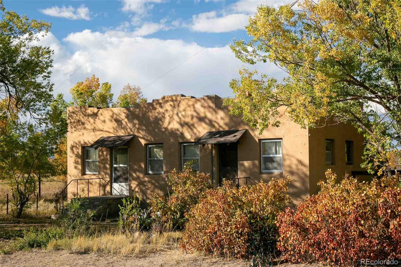 6771 West County Road Del Norte, CO 81132 - Photo 1 of 49 a front view of a house with garden