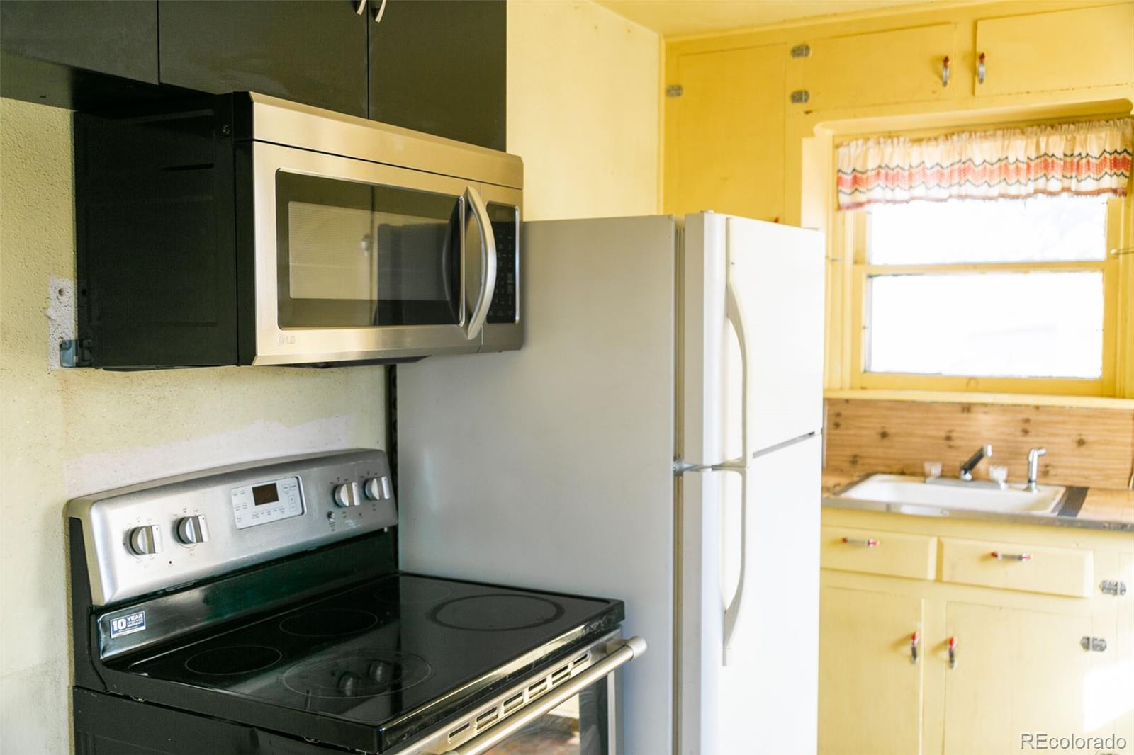 6771 West County Road Del Norte, CO 81132 - Photo 11 of 49 a kitchen with a stove and a microwave
