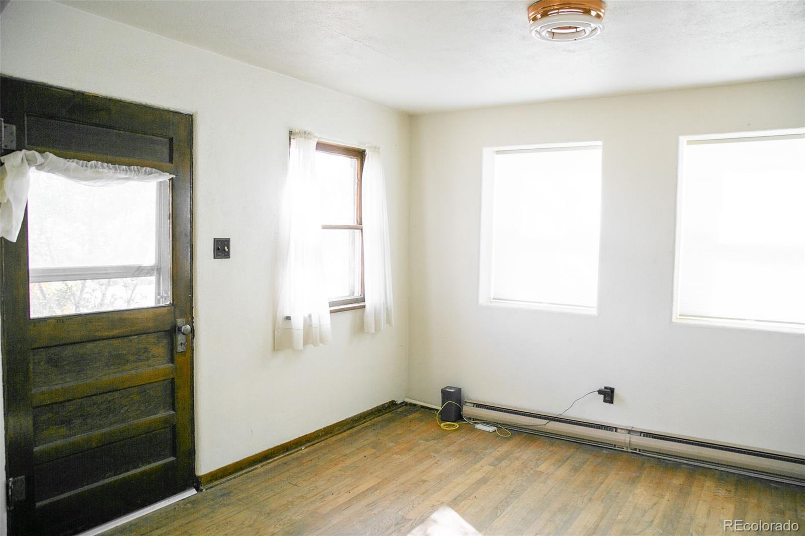 6771 West County Road Del Norte, CO 81132 - Photo 13 of 49 a view of a room with wooden floor and a window