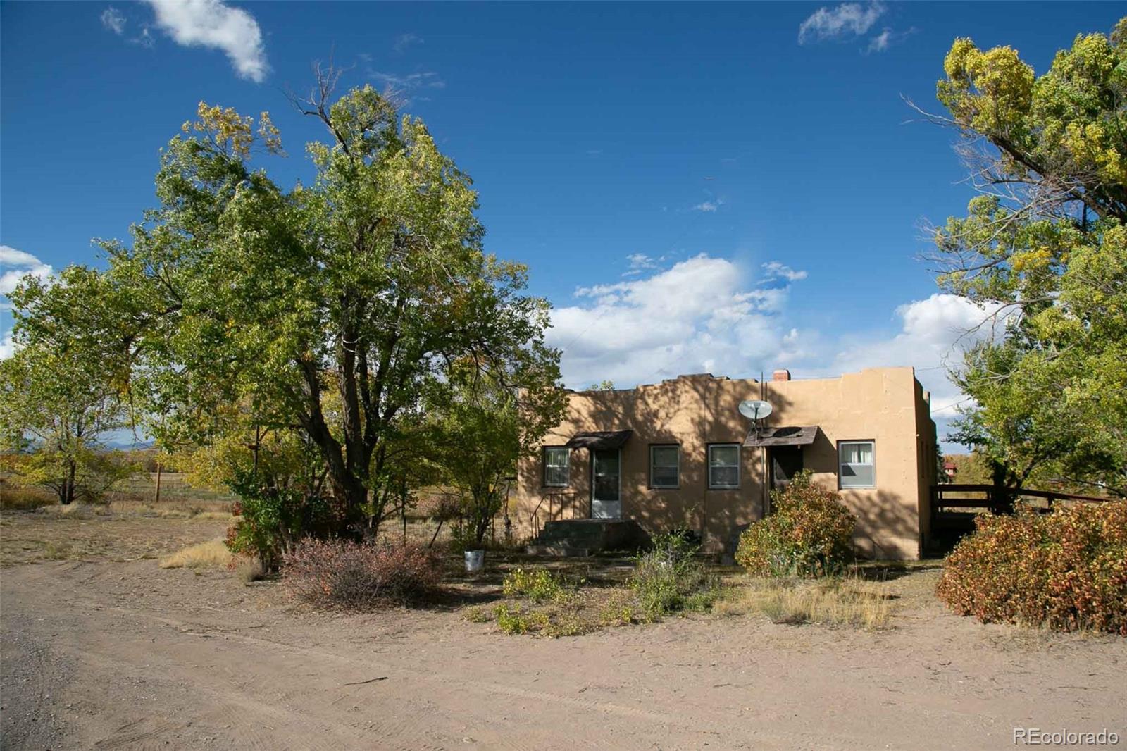6771 West County Road Del Norte, CO 81132 - Photo 38 of 49 a view of a house with a yard and garden