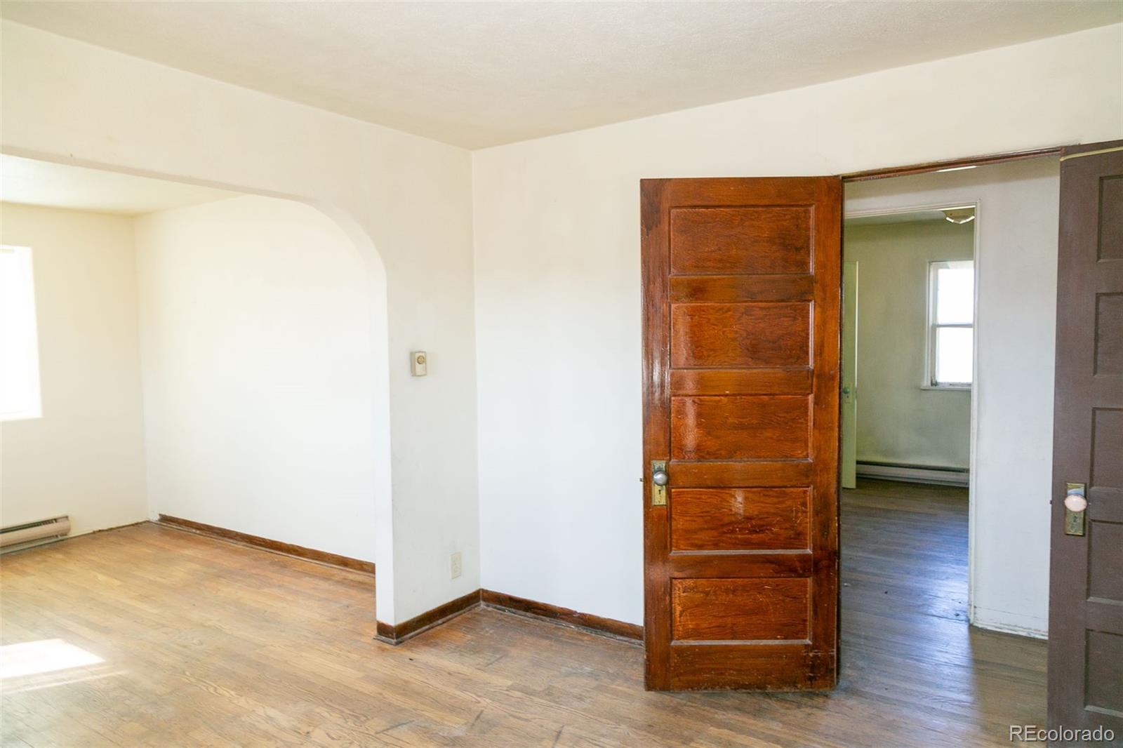 6771 West County Road Del Norte, CO 81132 - Photo 9 of 50 an empty room with wooden floor closet and windows