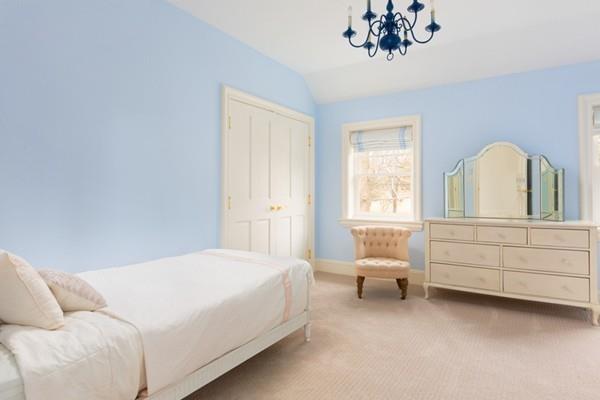 118 Marrett Road Lexington, MA 02421 - Photo 25 of 38 a bedroom with a bed and a chandelier