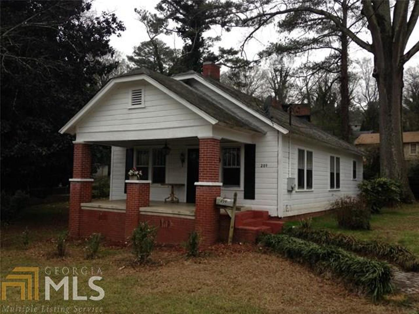 209 Pine Street Northeast Rome, GA 30161 - Photo 1 of 1 a front view of a house with garden