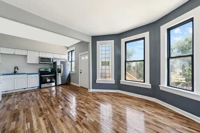 a view of a kitchen with microwave and windows