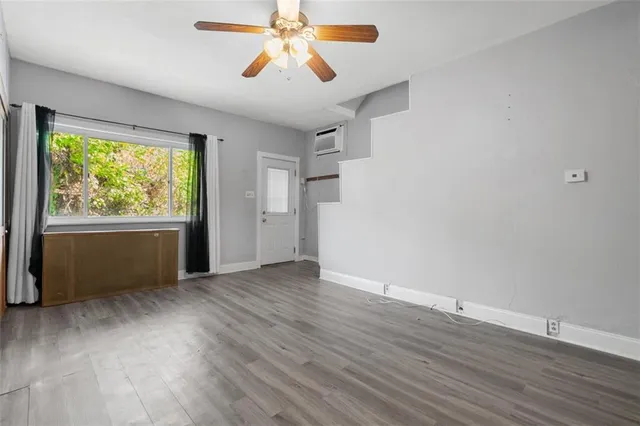 wooden floor in an empty room with a window