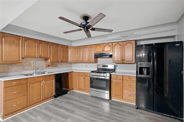 a kitchen with stainless steel appliances granite countertop a stove cabinets and refrigerator