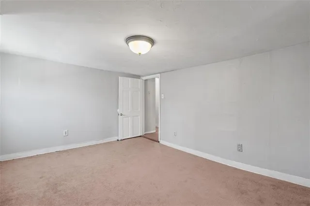 an empty room with a empty space and a window