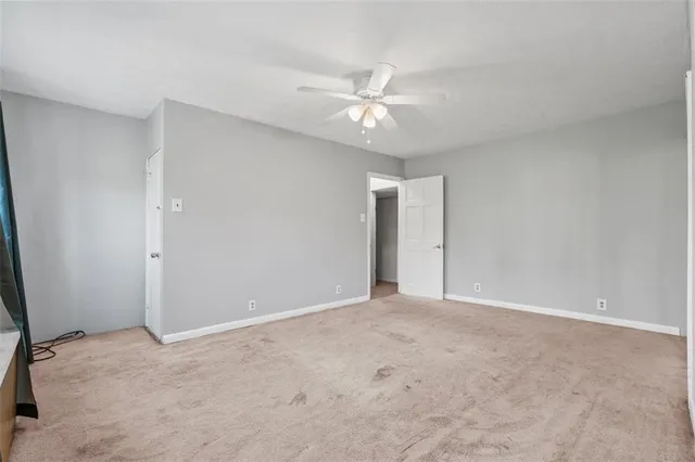 a view of an empty room with a ceiling fan