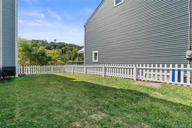 a view of a house with a backyard