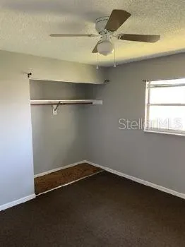 an empty room with a wooden floor and a window