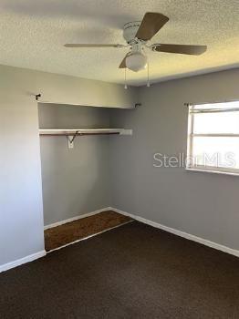 601 State Avenue, Unit 6 Daytona Beach, FL 32117 - Photo 4 of 7 an empty room with a wooden floor and a window