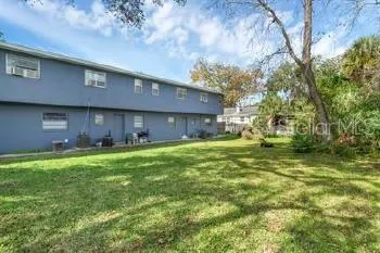 a front view of house with yard and trees in the background