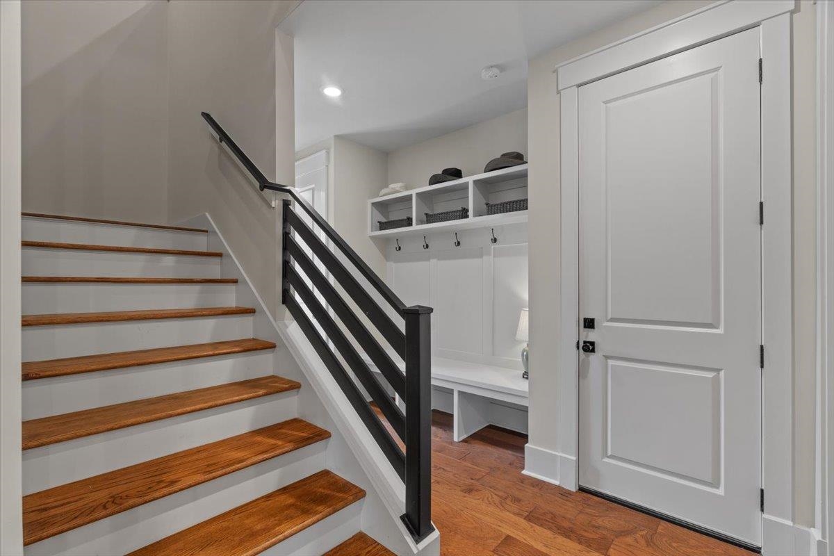 240 Burrows Road Collierville, TN 38017 - Photo 32 of 37 Staircase featuring wood treads and painted risers with a contemporary black metal baluster railing system