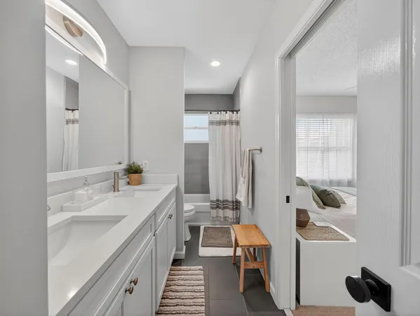 a bathroom with a sink a mirror and a bathtub