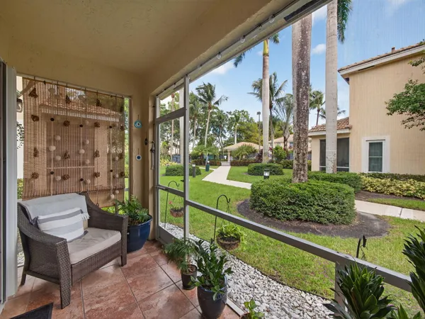 a view of a balcony with chair and a potted plant