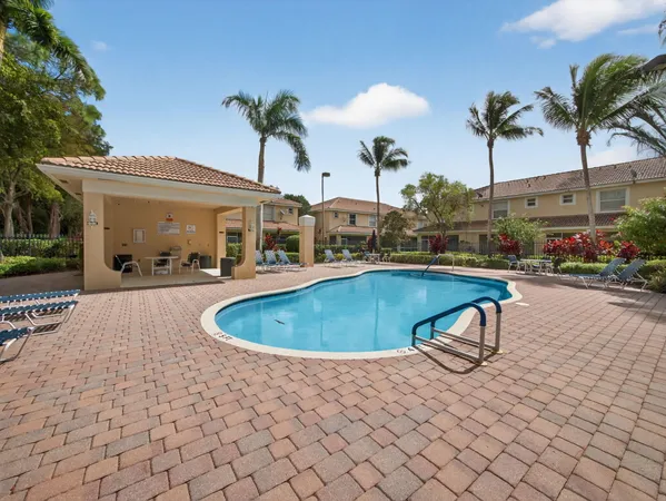 a swimming pool with outdoor seating and yard