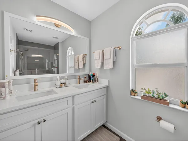 a bathroom with a double vanity sink and a mirror