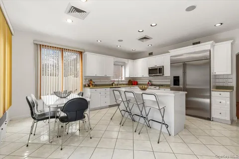a kitchen with white cabinets and white appliances